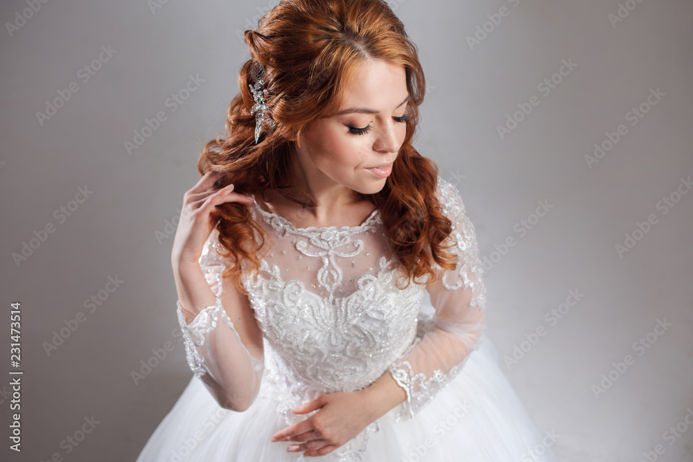 Portrait of a charming red-haired bride, Studio, close-up. Wedding hairstyle and makeup. Portrait of a charming red-haired bride, Studio, close-up. Wedding hairstyle and makeup.