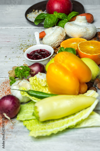 fresh vegetables  fruits  herbs nad spices on white wooden table