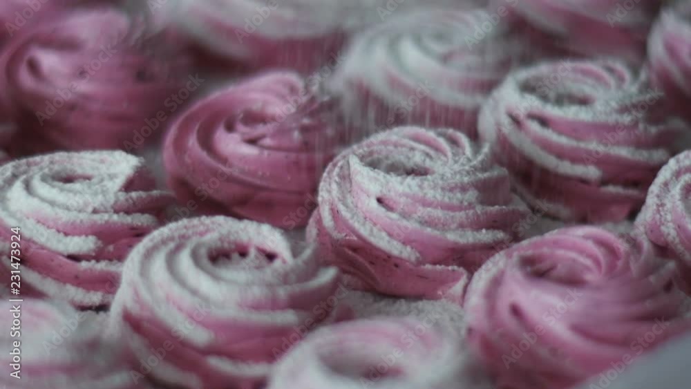 Confectioner sprinkles powdered sugar on marshmallow. Seamless cinemagraph video Confectioner sprinkles powdered sugar on marshmallow. Seamless cinemagraph video