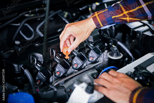 Close up hands checking lube oil level of car engine from deep-stick for service and maintenance concept © Goodvibes Photo