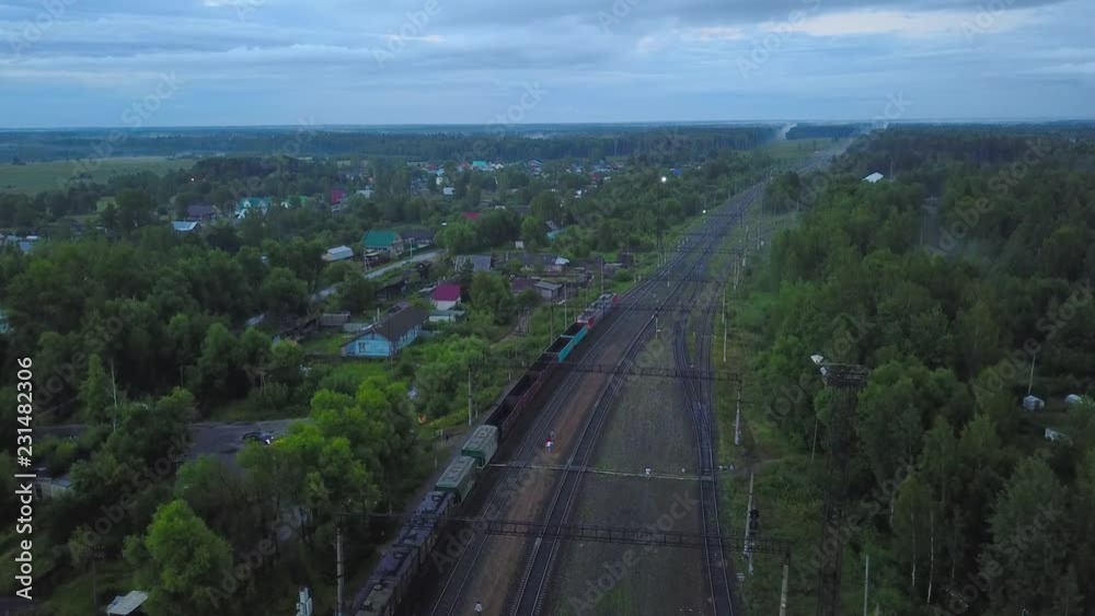 Railway with stopped freight train in countryside on summer evening, aerial Railway with stopped freight train in countryside on summer evening, aerial