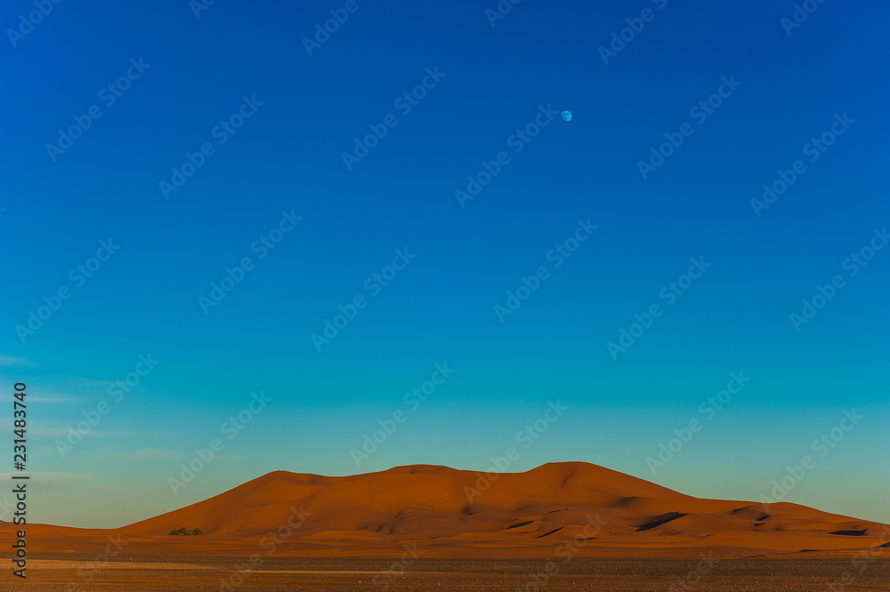 Full moon over the sand dunes of the Sahara, Merzouga, Morocco, Africa