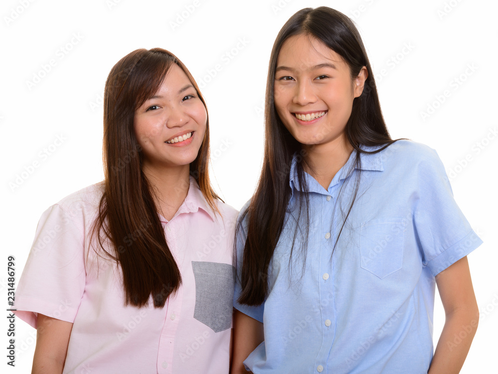Two young happy Asian teenage girls smiling Two young happy Asian teenage girls smiling