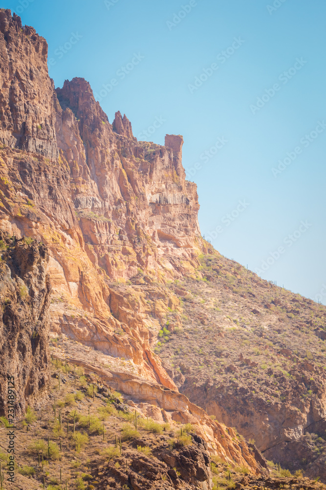The sheer red and orange cliffs surround Canyon Lake in the wilderness desert east of Phoenix Arizona cliffs reach to the sky in this natural surrounding