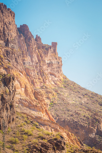 The sheer red and orange cliffs surround Canyon Lake in the wilderness desert east of Phoenix Arizona cliffs reach to the sky in this natural surrounding