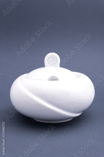 Ceramic white sugar bowl on grey background. Mock up for design.