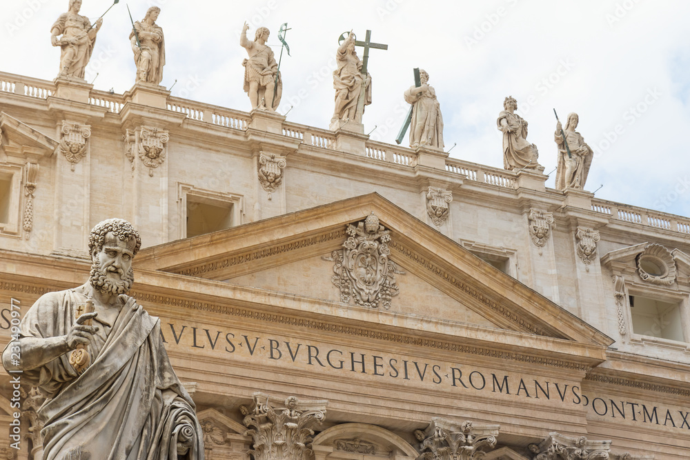 Closeup view of the St. Peter Statue. St. Peter's Basilica is in the background.