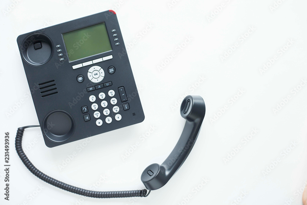 Deskphone, office and business concept. New ip phone with buttons and big display for communication without interference. Top view. Space for a text. Close up. Deskphone, office and business concept. New ip phone with buttons and big display for communication without interference. Top view. Space for a text. Close up.