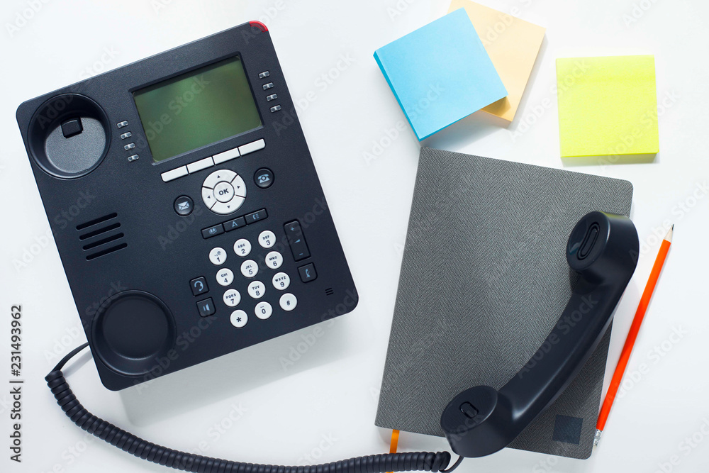 Deskphone, office and business concept. New ip phone with buttons and big display for communication without interference. Top view. Space for a text. Close up. Deskphone, office and business concept. New ip phone with buttons and big display for communication without interference. Top view. Space for a text. Close up.
