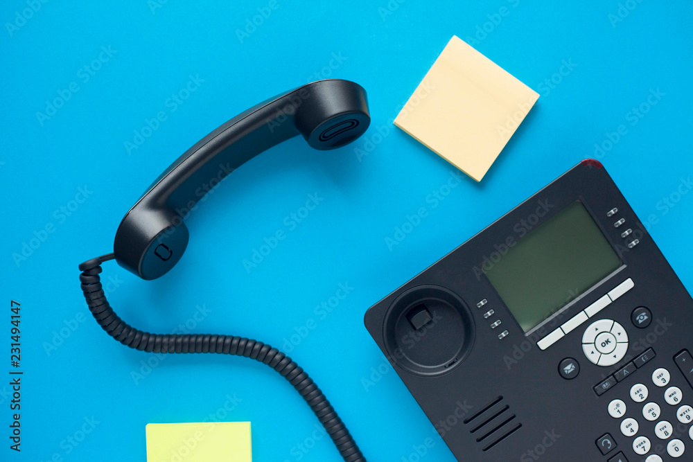 Deskphone, office and business concept. New ip phone with buttons and big display for communication without interference. Top view. Space for a text. Close up. Deskphone, office and business concept. New ip phone with buttons and big display for communication without interference. Top view. Space for a text. Close up.