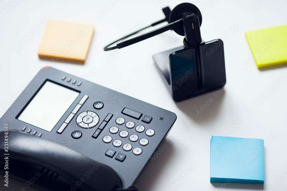 Deskphone, office and business concept. New ip phone with buttons and big display for communication without interference. Top view. Space for a text. Close up. Deskphone, office and business concept. New ip phone with buttons and big display for communication without interference. Top view. Space for a text. Close up.