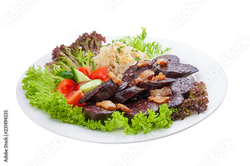 Blood sausage with vegetables and salad. On a white plate