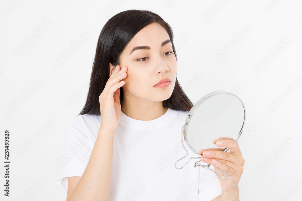 Asian woman looking in mirror. Macro japanese female face isolated on white background. Skin care and beauty spa concept. Anti aging and collagen. Copy space Asian woman looking in mirror. Macro japanese female face isolated on white background. Skin care and beauty spa concept. Anti aging and collagen. Copy space
