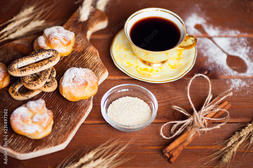 Beautiful set of bakery products and vintage cup of tea. Flat lay composition of breakfast food on the wooden background. Food, break, cooking, lifestyle concept. Top view. Close up.
