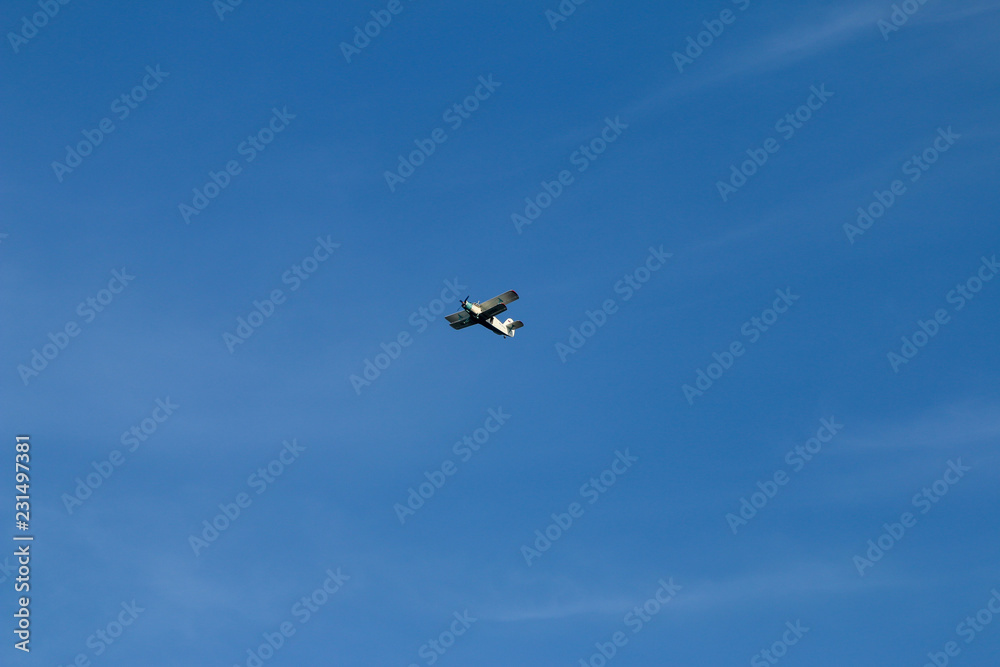 the plane is flying in the blue sky the plane is flying in the blue sky