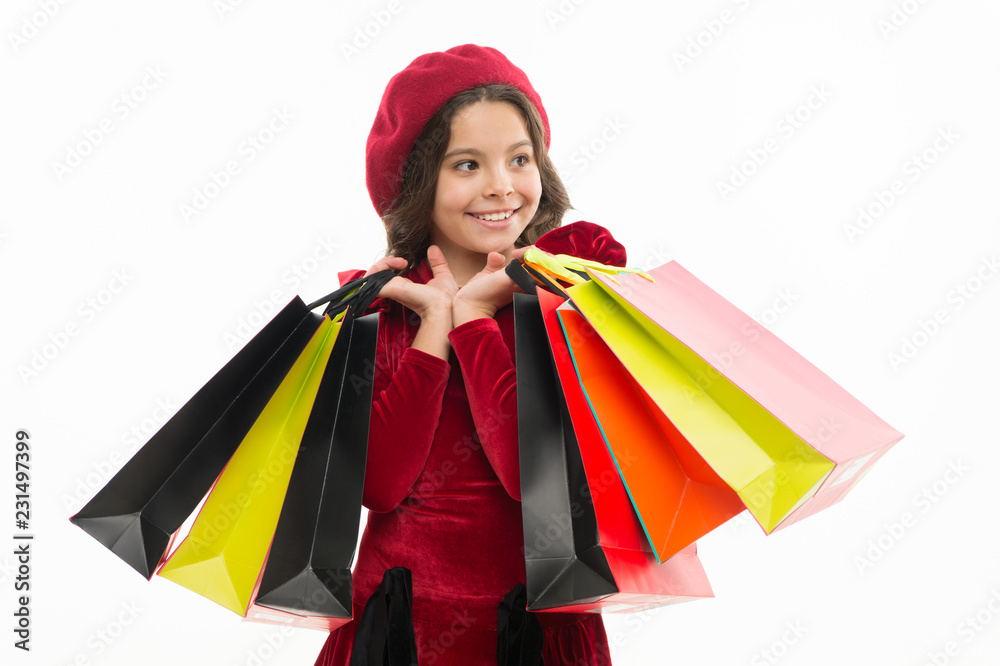 Pleasant shopping. Small child with paper bags. Little shopper. Small girl with shopping bags. Girl child enjoy shopping. Little shopaholic with paperbags. Shopping is an addiction