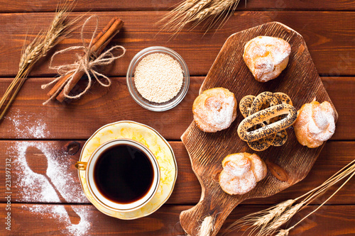 Beautiful set of bakery products and vintage cup of tea. Flat lay composition of breakfast food on the wooden background. Food, break, cooking, lifestyle concept. Top view. Close up.