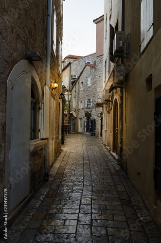 Narrow streets of the old stone town with stone blocks. © freeman83