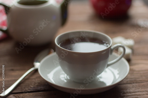 Hot tea in white Cup on wooden table
