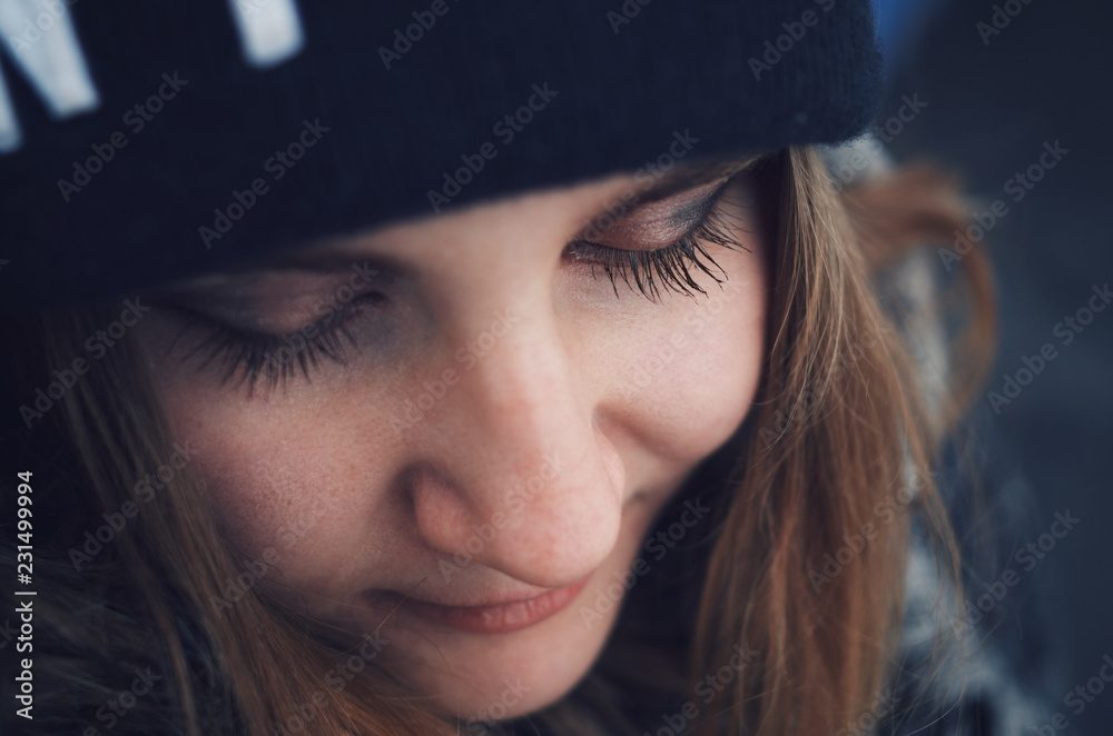Close-up portrait of a beautiful girl with a blue warm hat. Close-up portrait of a beautiful girl with a blue warm hat.
