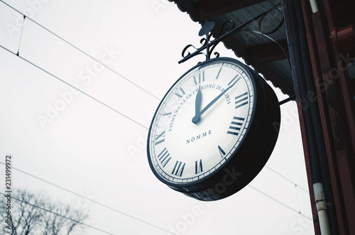 Low angle close-up of an old vintage clock in a railway station.