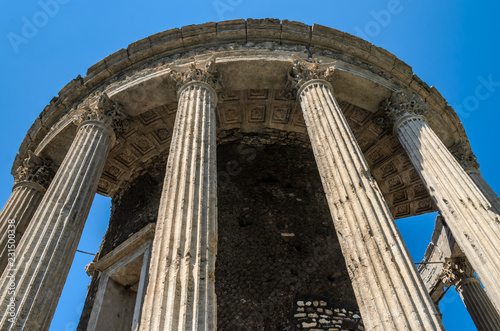 Ruins with columns of the ancient temple of the goddess Vesta in Tivoli, Italy photo