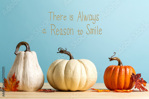 There is always a reason to smile message with pumpkins on a blue background