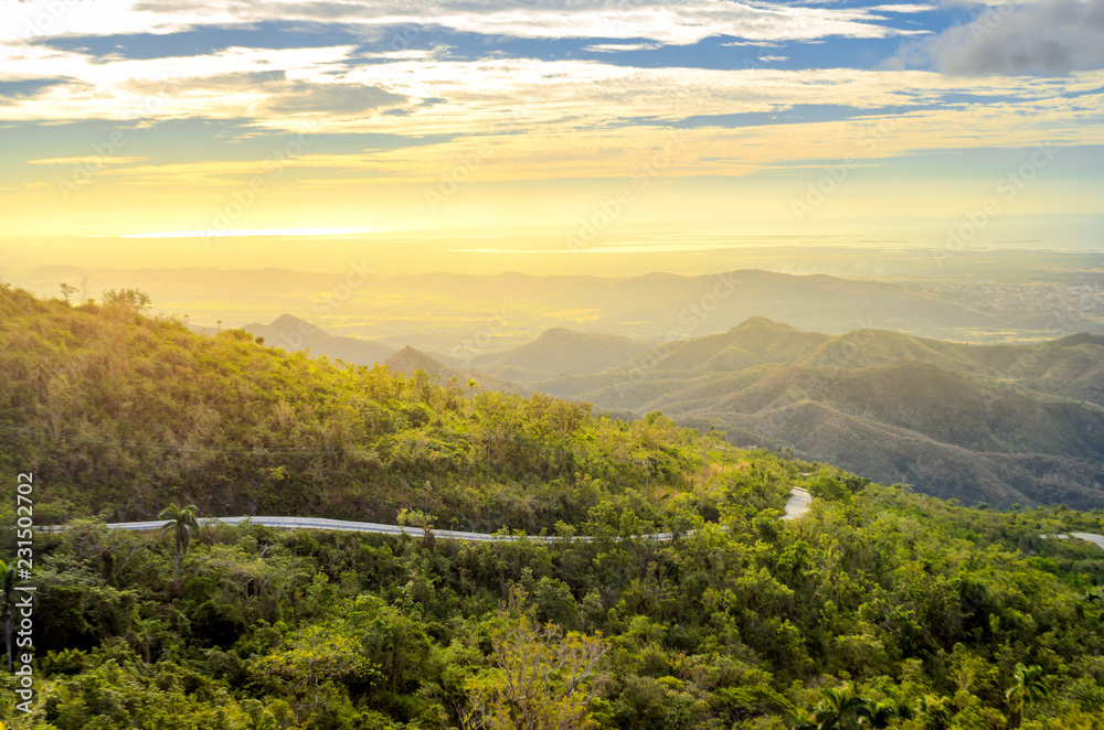 idyllic landscape of the Cuban province at sunset, roads on the hillsides leading to the coast