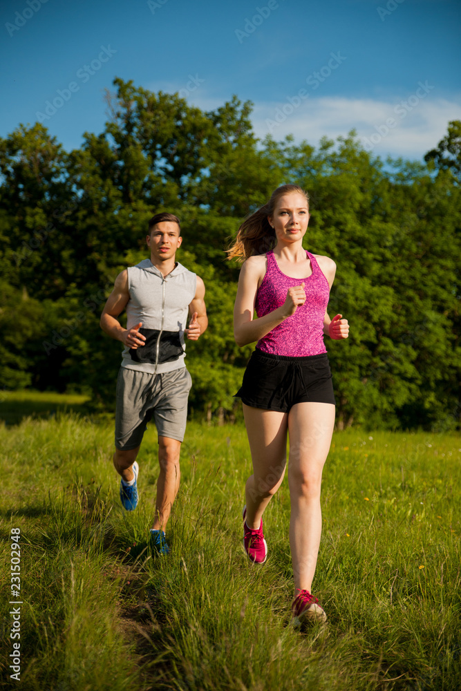 Active young couple running in the park Active young couple running in the park