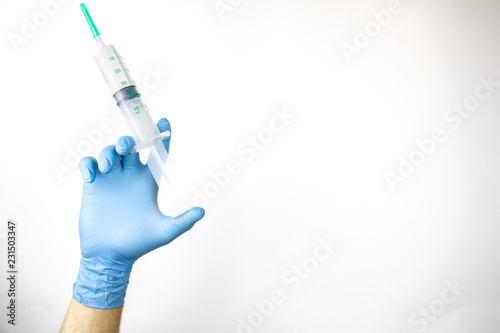 Man's hands in medical gloves, medical syringe