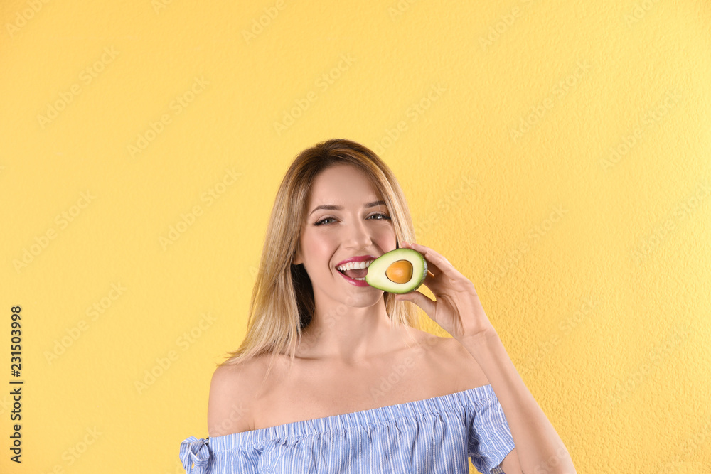 Portrait of young beautiful woman with ripe delicious avocado on color background Portrait of young beautiful woman with ripe delicious avocado on color background