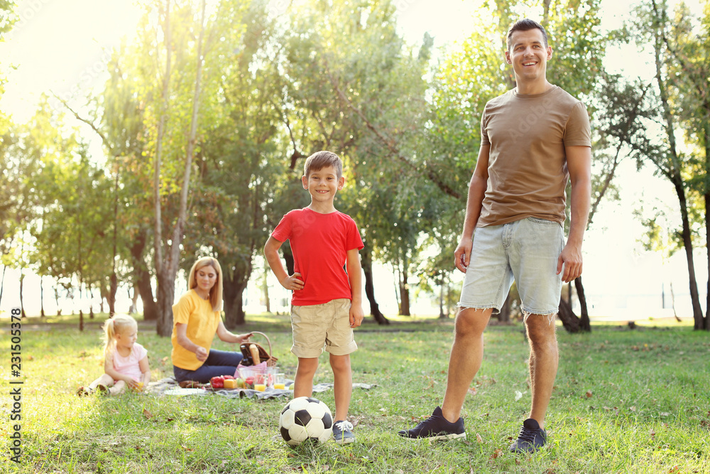 Happy family having picnic in park on sunny day Happy family having picnic in park on sunny day