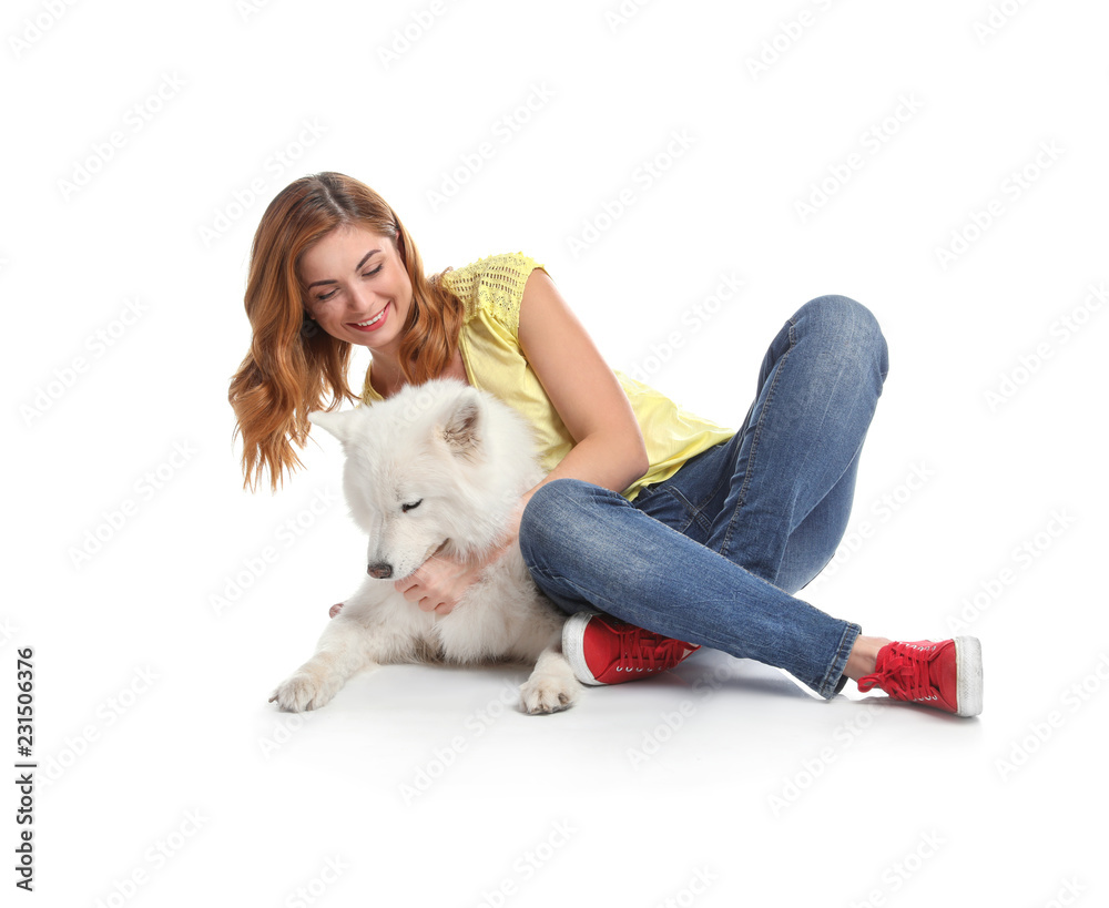 Beautiful woman hugging her dog on white background