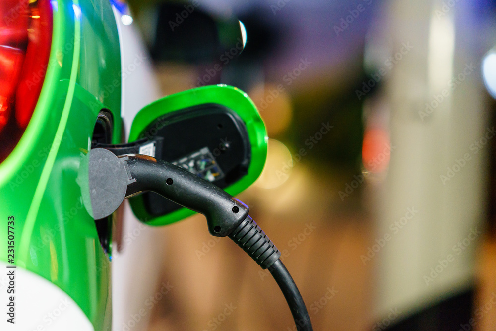 Electric Vehicle is charging in charging station. Electric Vehicle is charging in charging station.