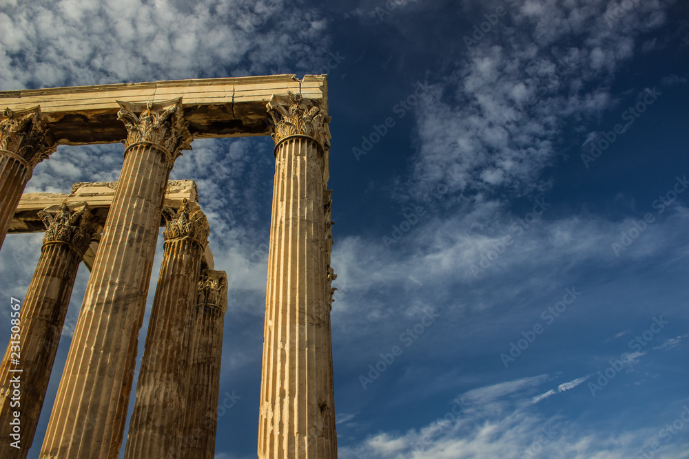 example of Greek architecture ancient columns ruins of old antique heritage temple shape on vivid blue sky background, empty copy space