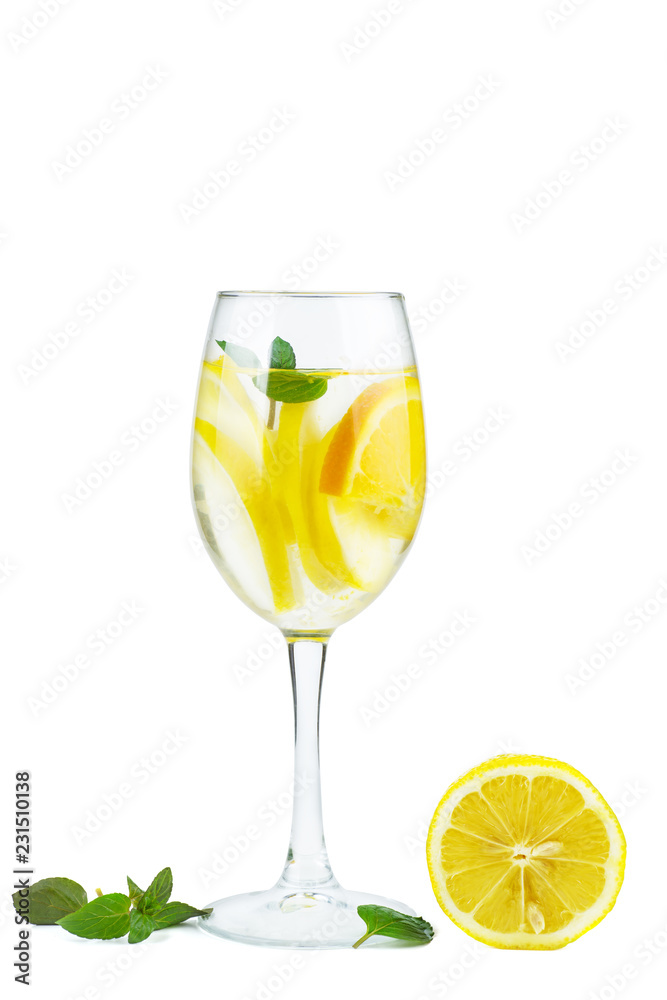 Wineglass with water (or alcohol), lemon slices and mint