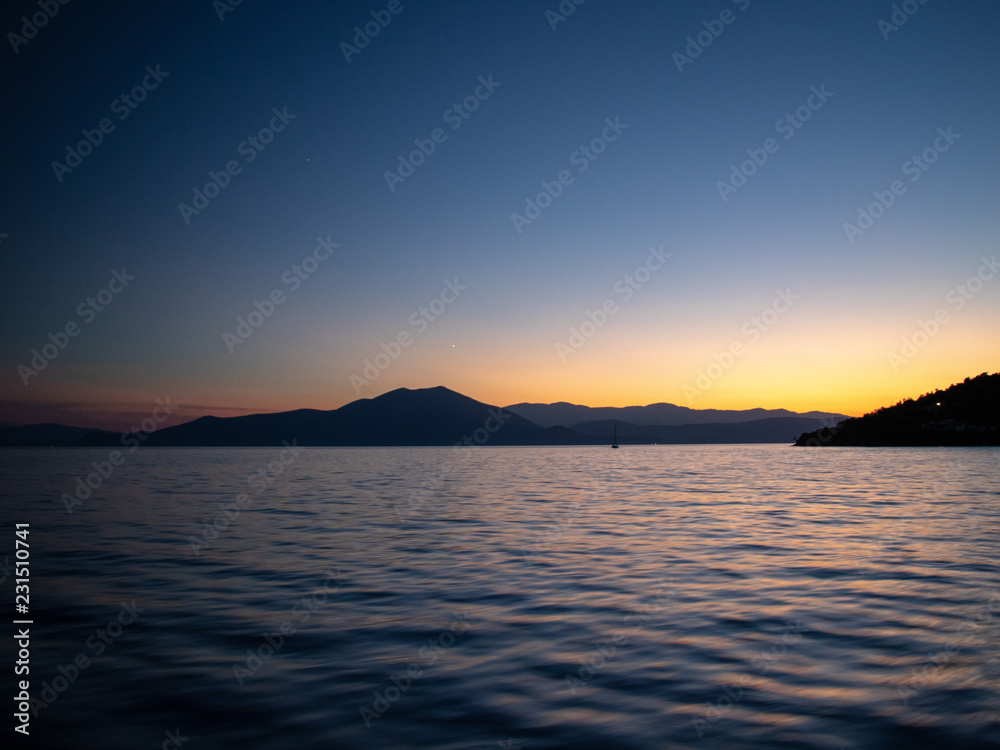Moody sunset scenery of yachts taken at aegean sea in greece on the sporades Island - Skopelos, Alonisos, Skiathos