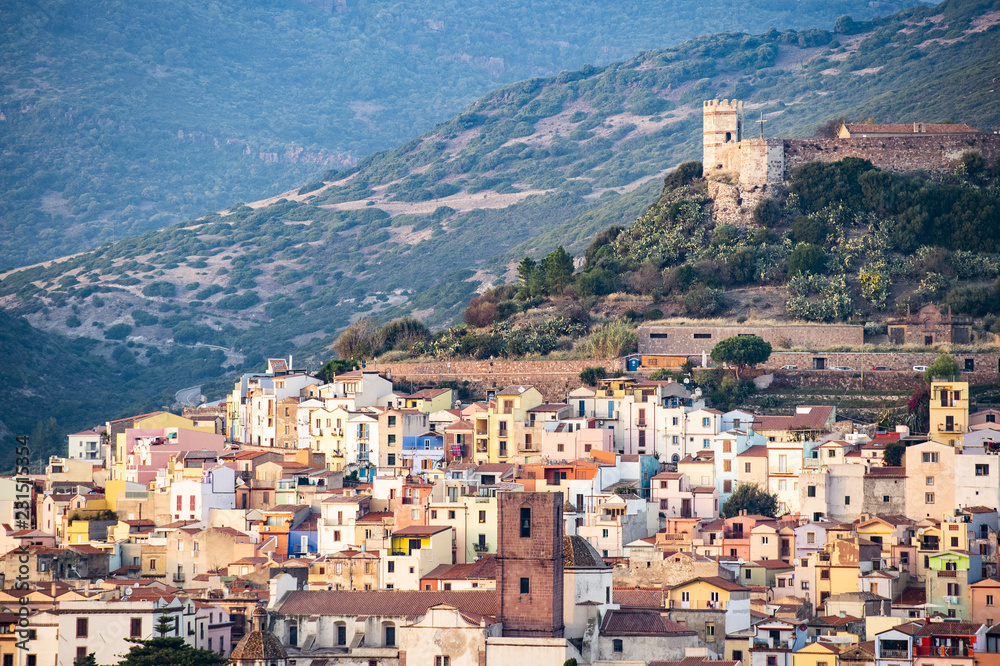 Fototapeta premium The beautiful village of Bosa with colored houses and a medieval castle on the top of the hill. Bosa is located in the north-west of Sardinia, Italy.