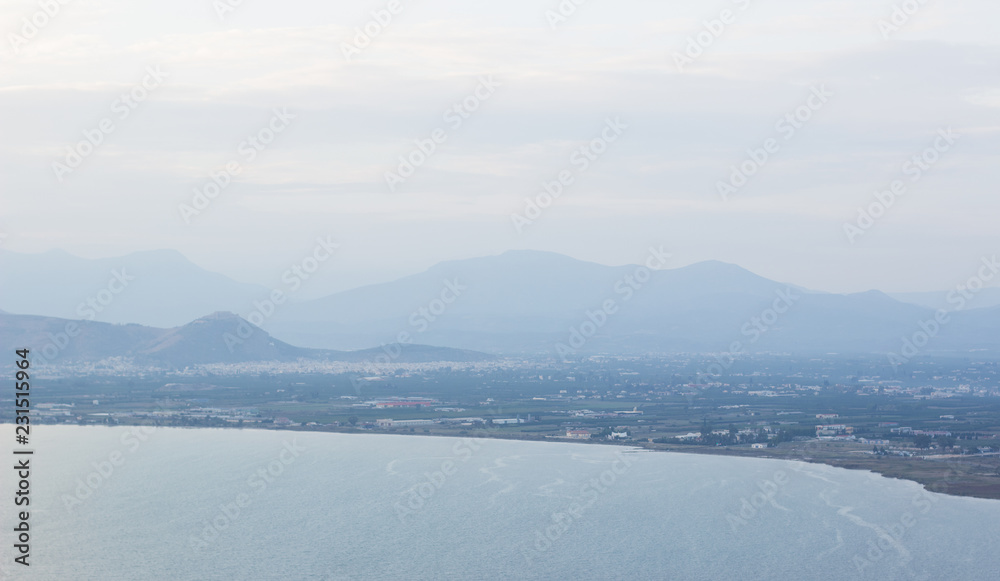 landscape mountain silhouette horizon shape in foggy weather time near sea shore waterfront line