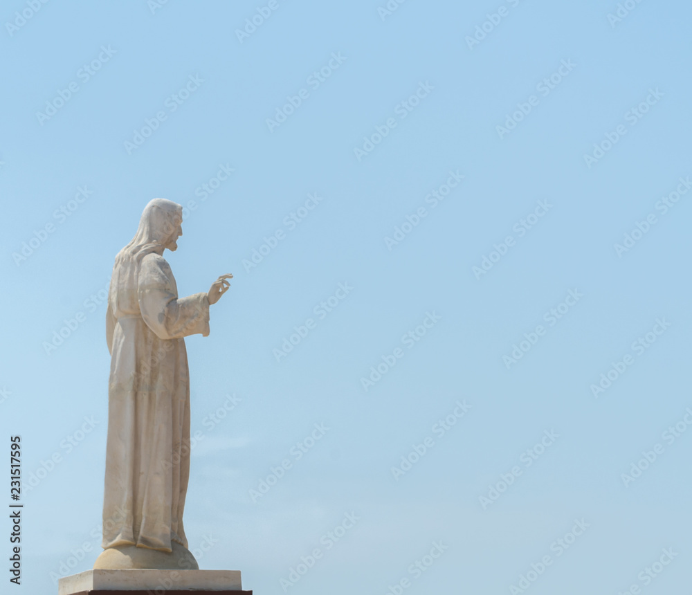 white statue of Jesus on the hill, place of prayers outside