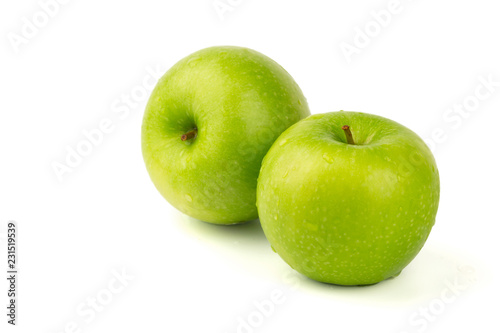 Macro shot of Fresh green apple with water drop isolated on white background.