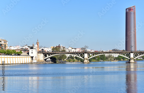 Panoramic view of the city of Seville, Gold - Bridge of Triana (Puente de Triana) and Tower Seville on background