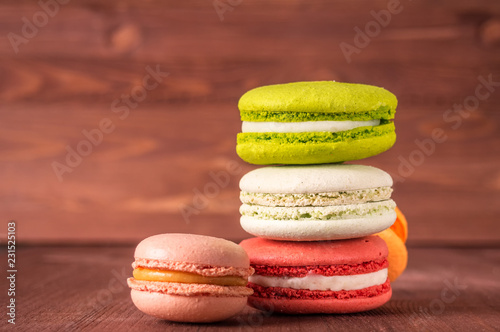 Fototapeta Naklejka Na Ścianę i Meble -  Colorful French or Italian macarons stack on wooden background put with copy space for background