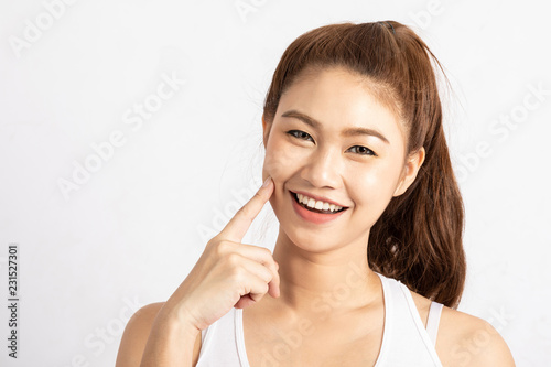 Beautiful Attractive Charming Asian young woman smile with white teeth and touching soft cheek feeling so happiness and cheerful with healthy skin,isolated on white background,Beauty Concept