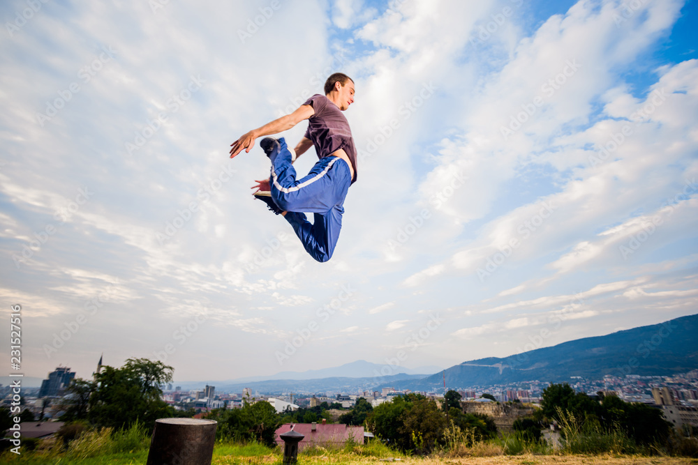 Sportive man make parkour tricks while jumping Sportive man make parkour tricks while jumping