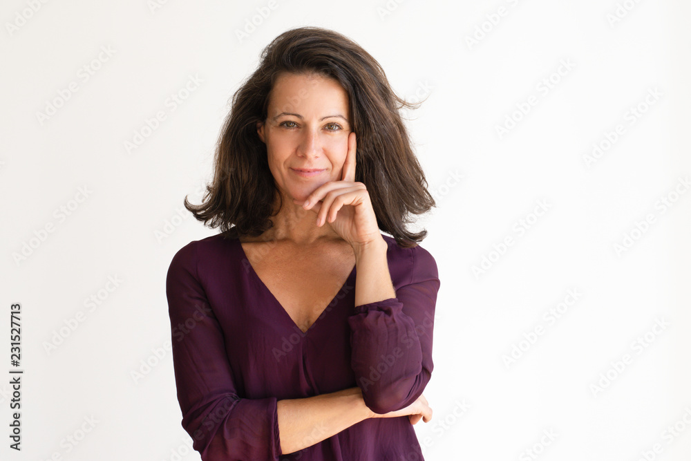 Confident woman holding hand on her face and thinking. Attractive pensive senior woman looking at camera. Isolated on white. Thinking concept Confident woman holding hand on her face and thinking. Attractive pensive senior woman looking at camera. Isolated on white. Thinking concept