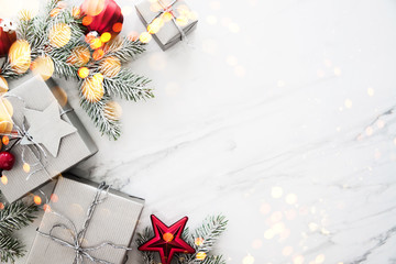 Christmas and New Year holiday background. Xmas greeting card. Christmas gifts on white marble background top view. Flat lay