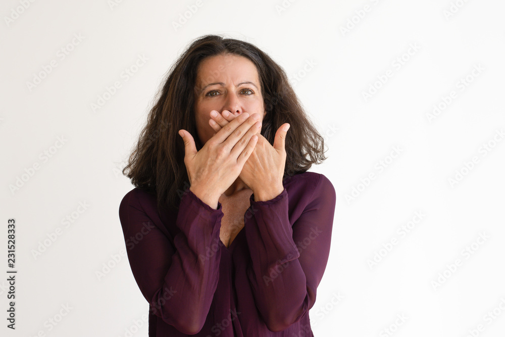 Shocked Caucasian woman covering mouth. Frightened woman heard bad news and looking at camera. Isolated on white. Shock expression concept Shocked Caucasian woman covering mouth. Frightened woman heard bad news and looking at camera. Isolated on white. Shock expression concept