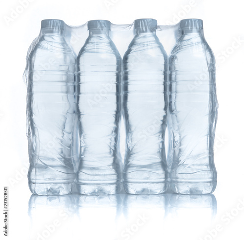 Plastic bottles water in wrapped package on white background