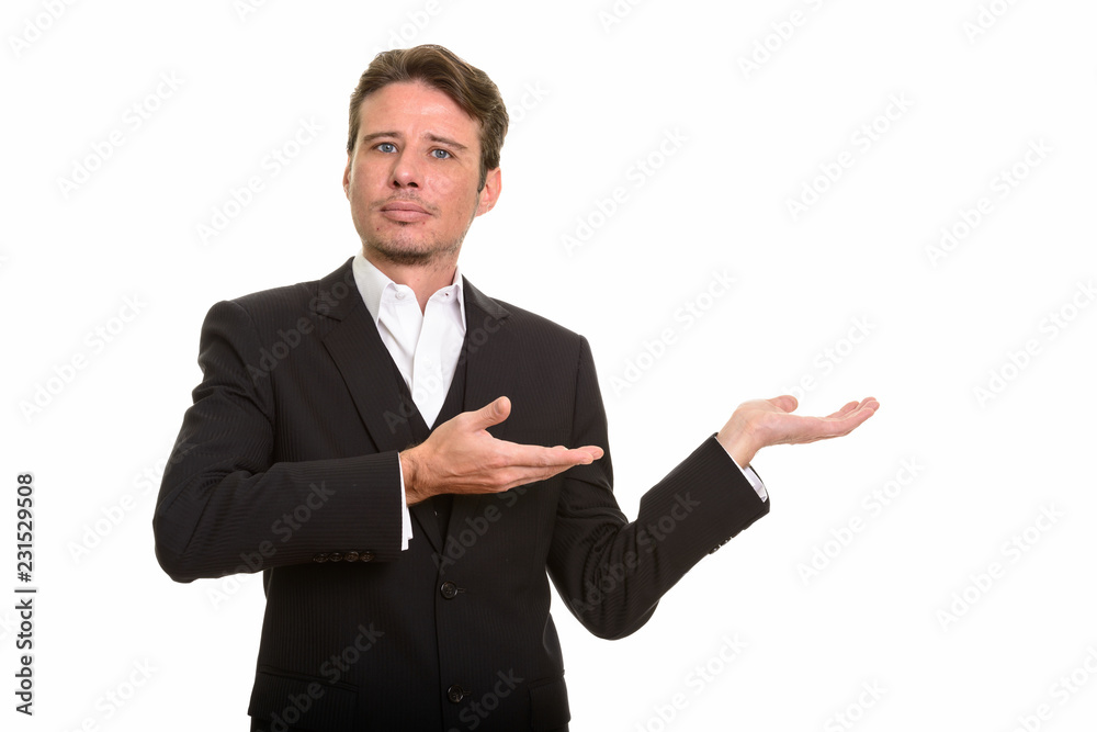 Handsome Caucasian businessman showing something and looking at camera Handsome Caucasian businessman showing something and looking at camera